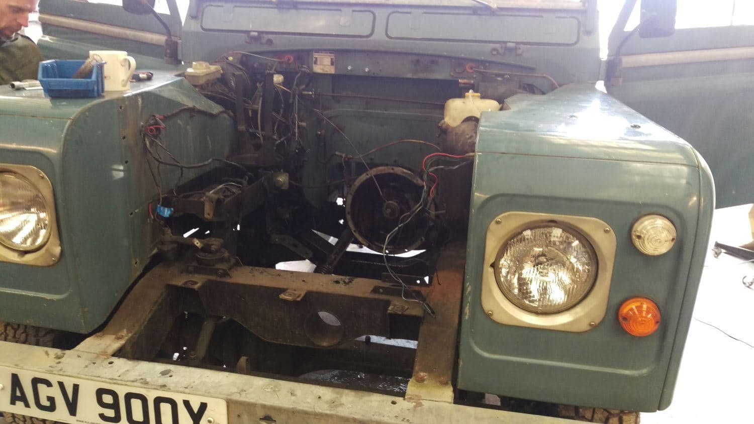 Green Series 3 Land Rover with its engine bay open during a 200Tdi conversion
